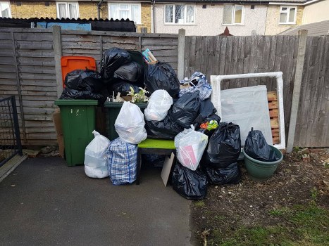 Van and crew loading commercial waste outside a shop in Addiscombe