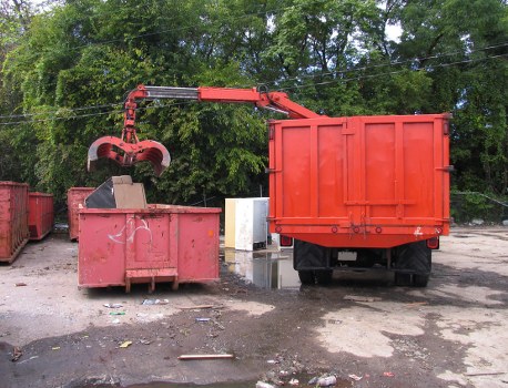 Worker wearing PPE while segregating recyclable materials